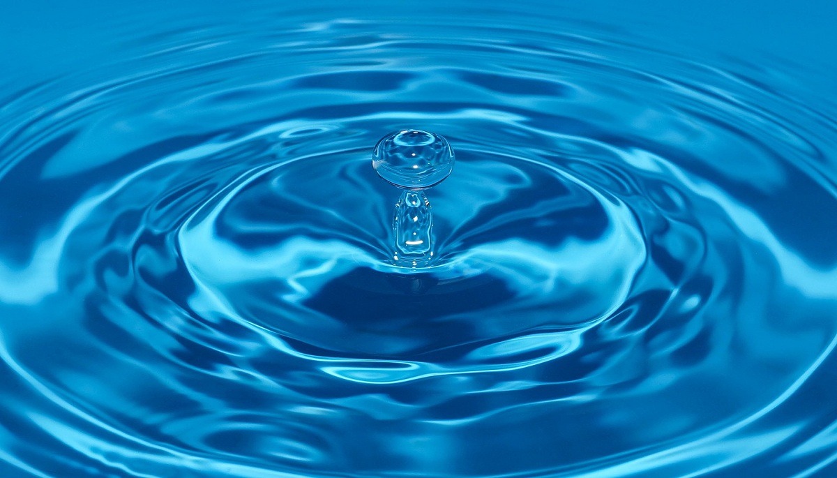 single water drop creates expansive circular ripples