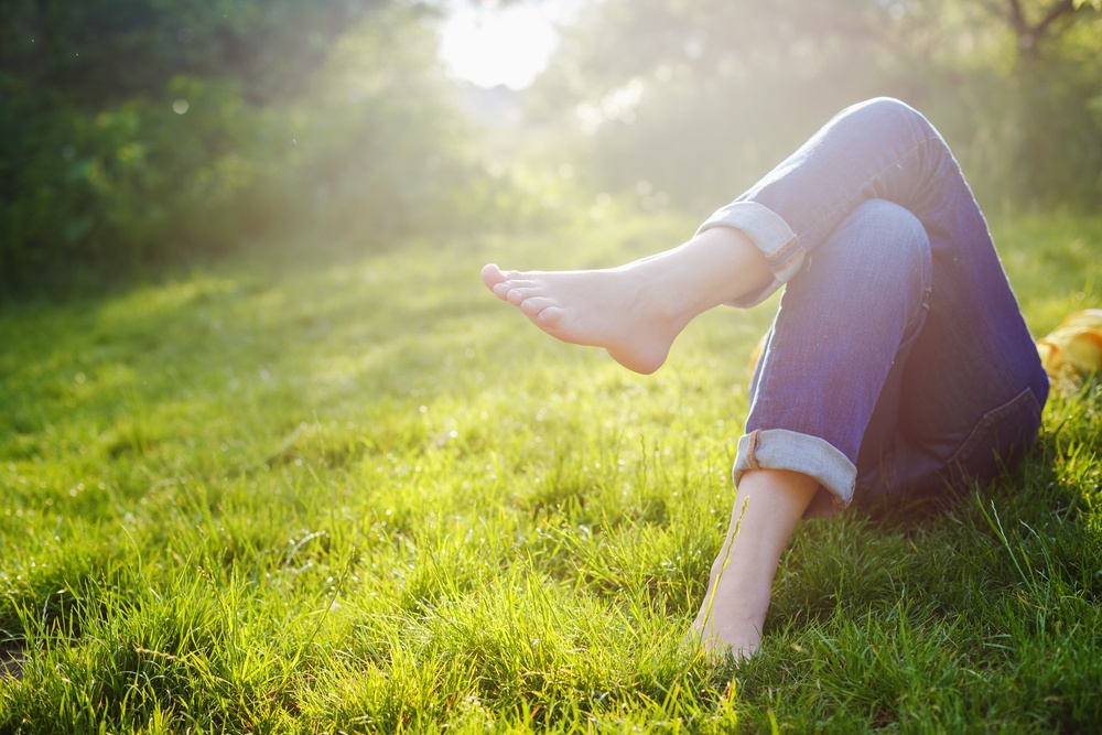 How Do You Trust in God - Resting and Trusting are linked - Rest comes from Trust in God - photo of a girl relaxing in meadow - Shutterstock