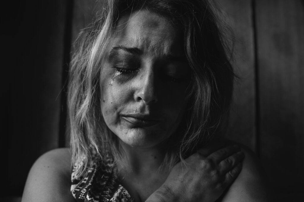 When God is Not Who You'd Prefer Him to Be - suffering - a woman crying - photo by Kat J - Unsplash