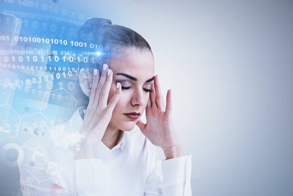 Too much information - woman closes her eyes as binary numbers swirl around her head - Shutterstock