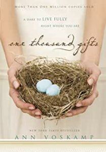 book cover One Thousand Gifts, by Ann Voskamp - a girl's hands holding a nest sheltering eggs