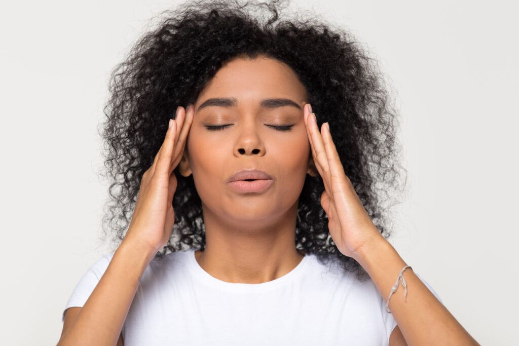 Black woman exhales to release stress