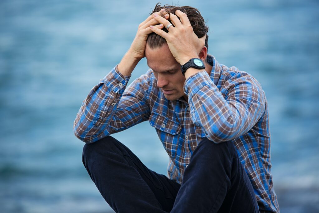 When You Can't Pray Anymore - despairing man sits on the ground, holding his head in his hands - photo by Nathan Cowley - Pexels