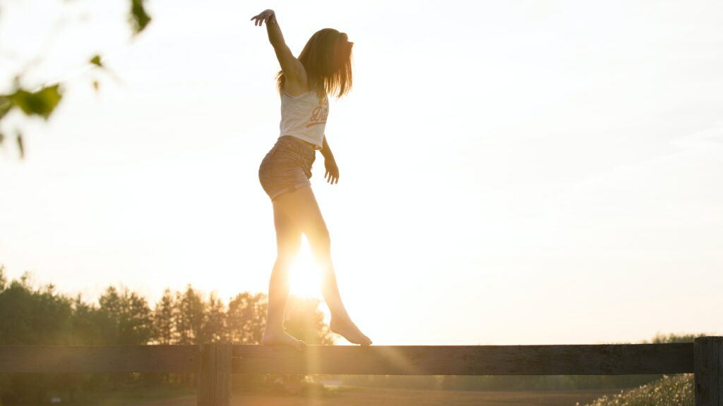 How to Embrace This Liminal Space - the balancing act of waiting between what was and what will be - a girl walks on a balance beam - photo by Sebastian Voortman