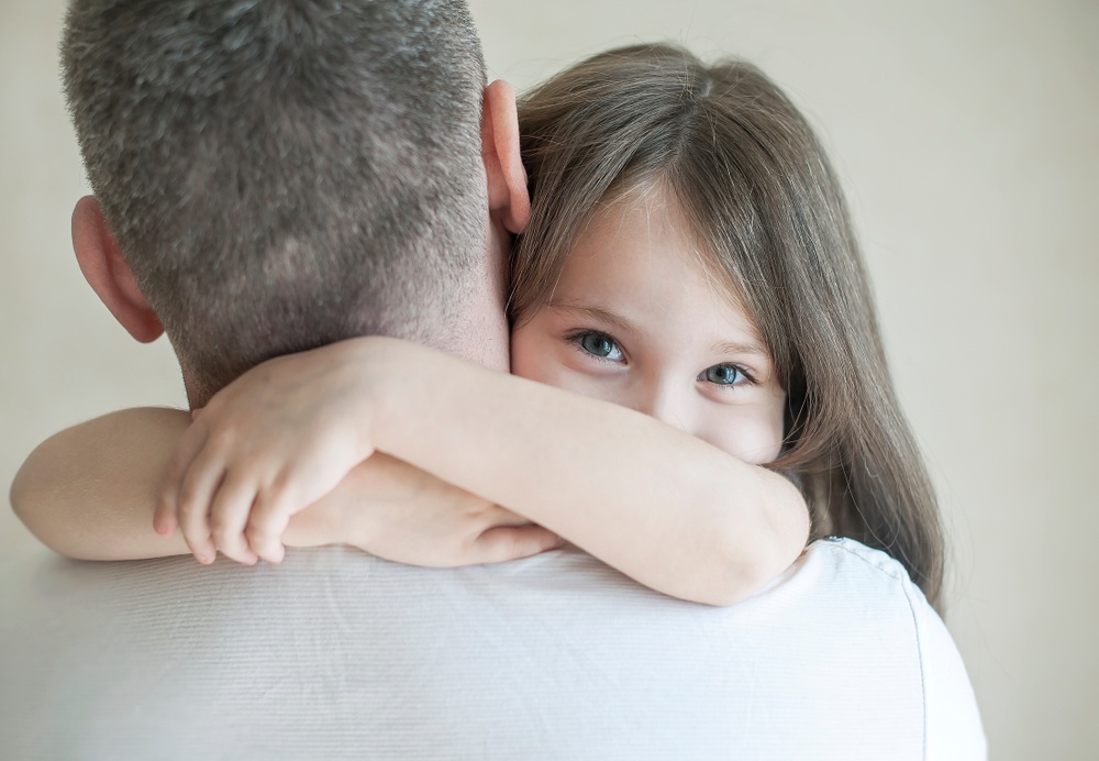 God picks you up when you fall down - he never lets you go - Father holds smiling daughter - Shutterstock