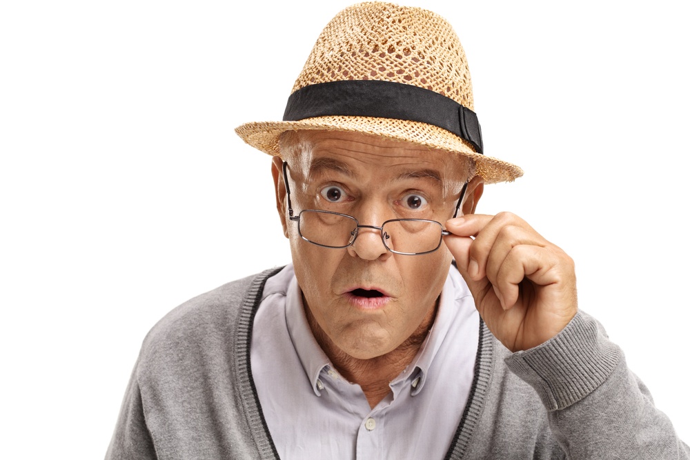 Mindfulness and Aging - it's all about perspective - surprised elderly man adjusts his glasses - Shutterstock