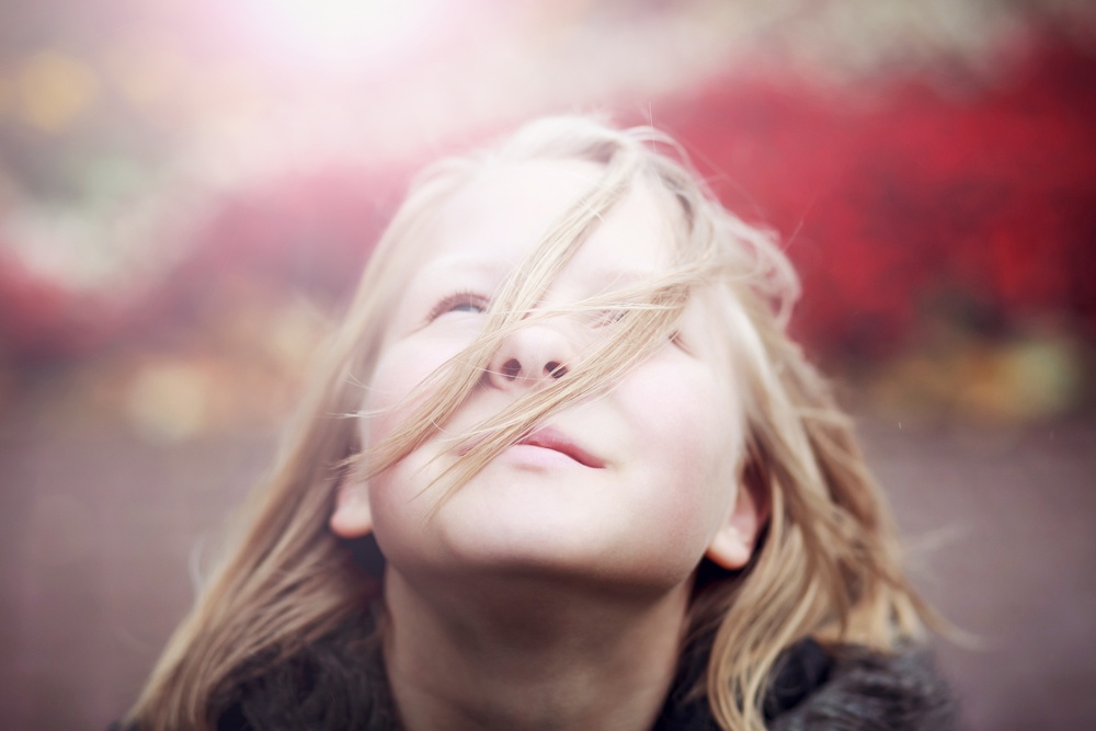 The God Who Pursues You - listen for His voice in the quiet - little girl looks to the sky - Shutterstock