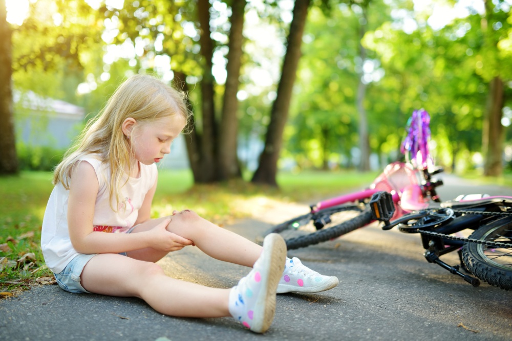 The God Who Pursues You - you stumble and fall but God doesn't give up on you - little girl falls off bike and skins her knee - Shuttestock