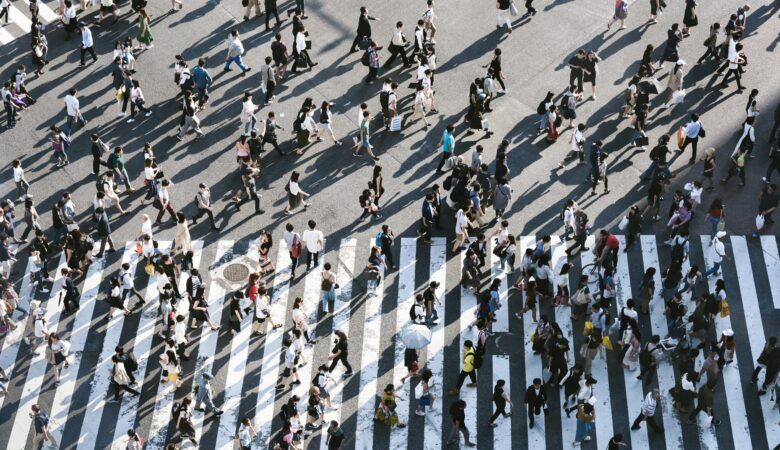 hundreds of people crossing the street at the busiest crosswalk in the world in Tokyo