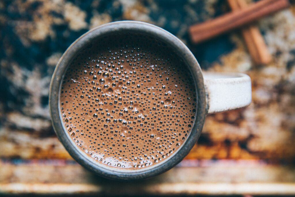 the frothy top view of a hot cup of cocoa