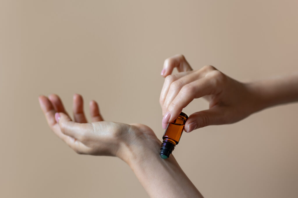 Aromatherapy rollerball application on wrist - iStock 1784092764