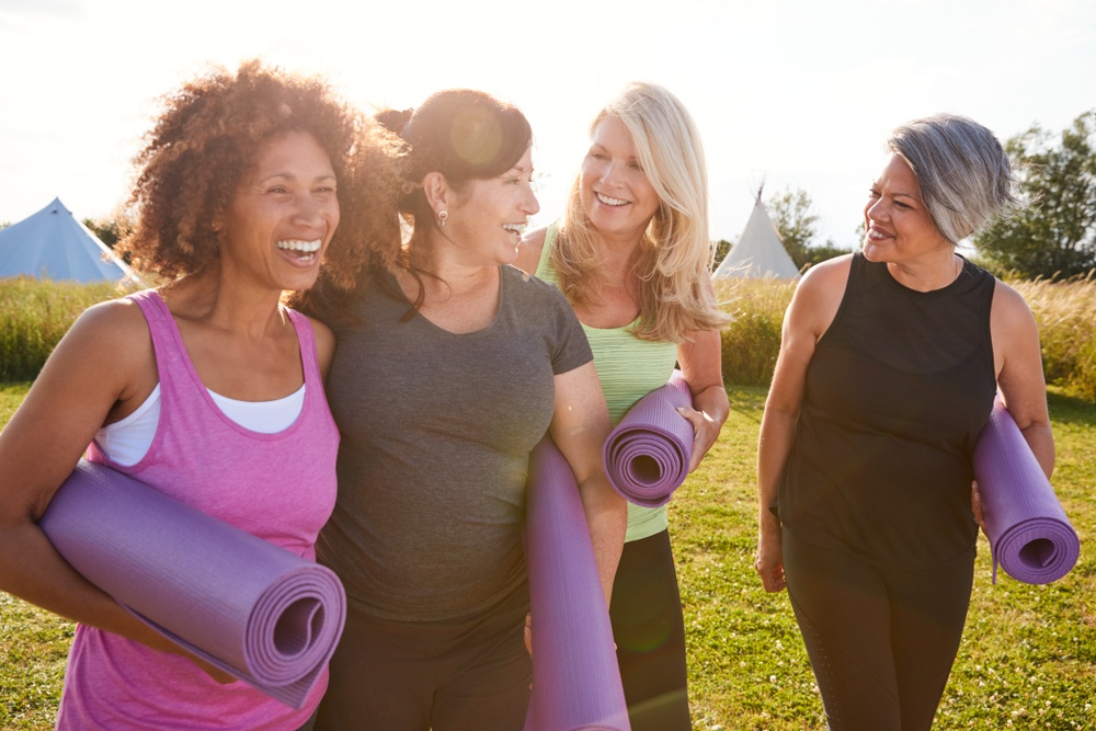 enjoying Holy Yoga is one way to combine Breath Prayer with movement - happy women after a yoga class - Shutterstock