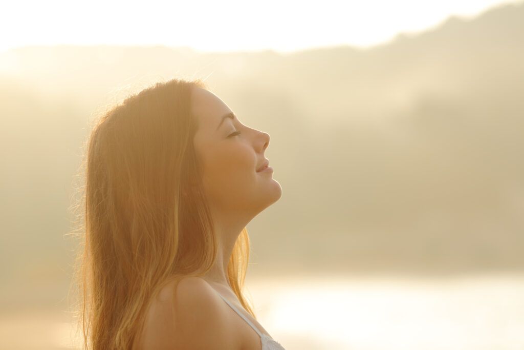 woman breathing fresh air and experiencing breath prayer