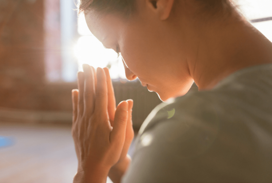 Christian Meditation - set your intention to seek the Living God - woman with hands in prayer