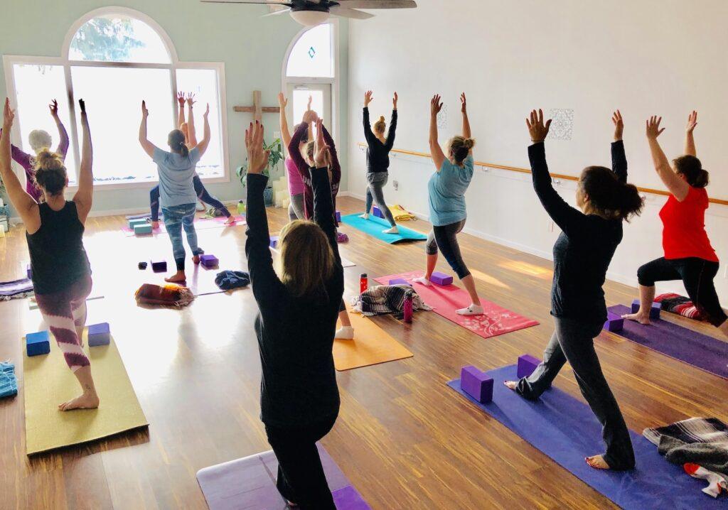 Holy Yoga class of women worshiping God - photo by Holy Yoga of Connecticut