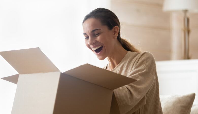 meaningful birthday gift ideas - happy woman opens box - best present ever
