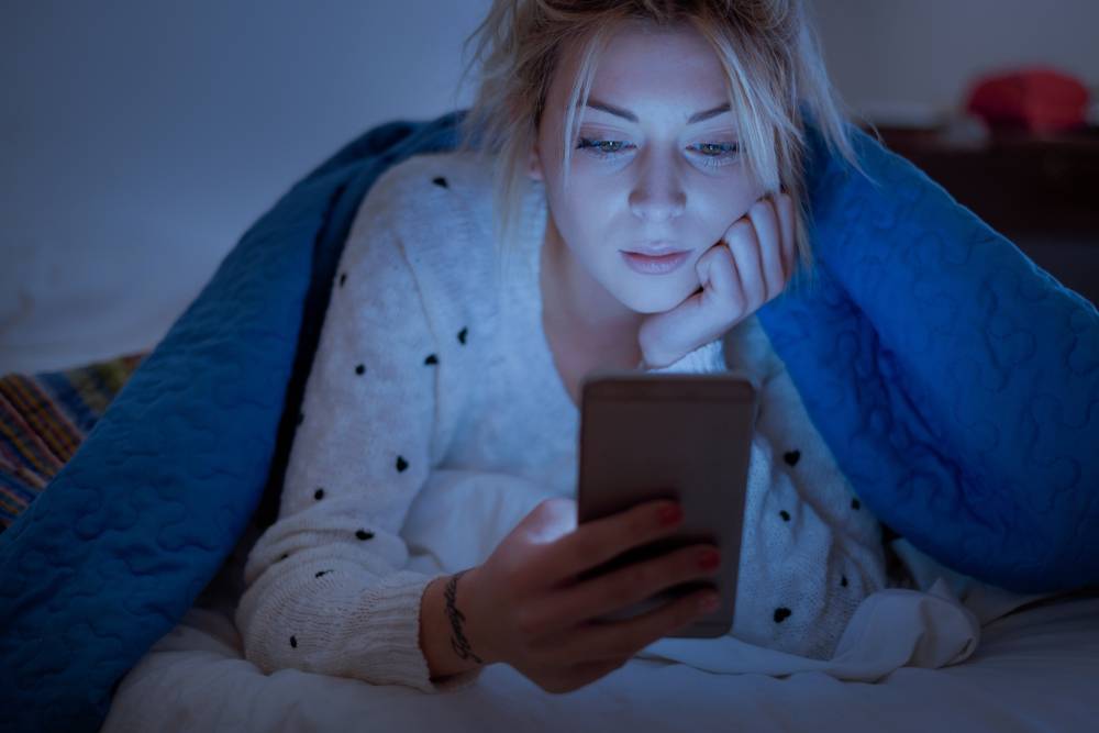 Why I Can't Sleep - the infamous smartphone - insomniac young woman in bed with phone