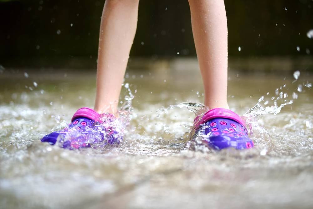 Child's Feet - playing in the rain wearing rubber shoes