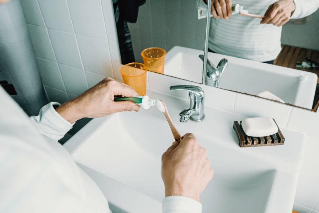 Dealing with Monotony - routine daily tasks - person puts toothpaste on a toothbrush - photo from Pexels