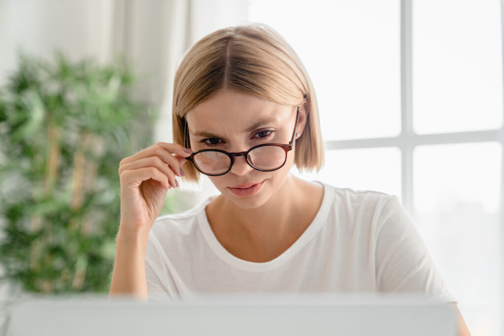 Woman Seriously Editing Her Literary Work - Perfectionism - iStock 2076382354