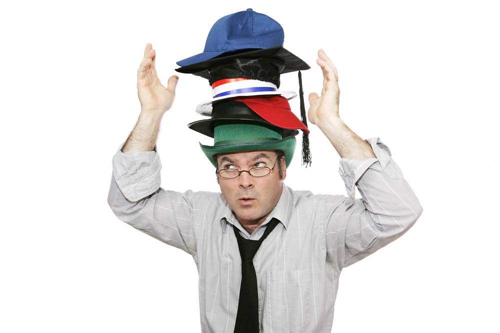 Businessman Wearing Too Many Hats