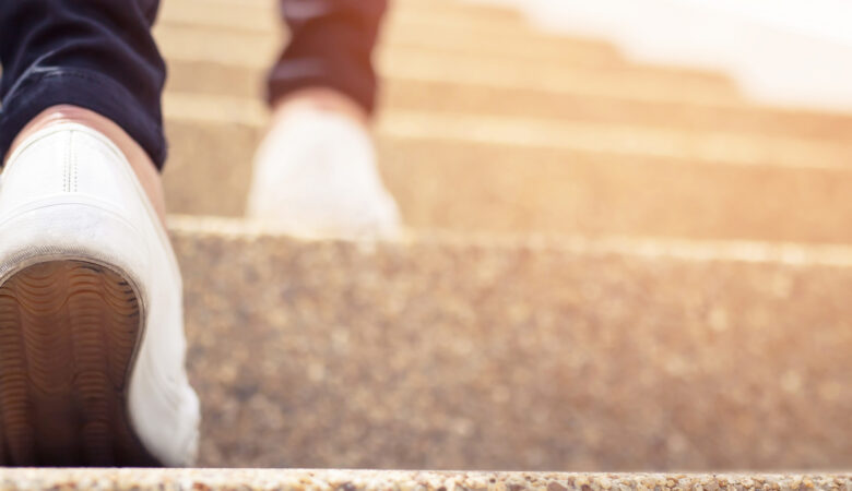 Woman's sneakers, climbing steps. Simply take a step - Do the next thing. photo credit iStock.