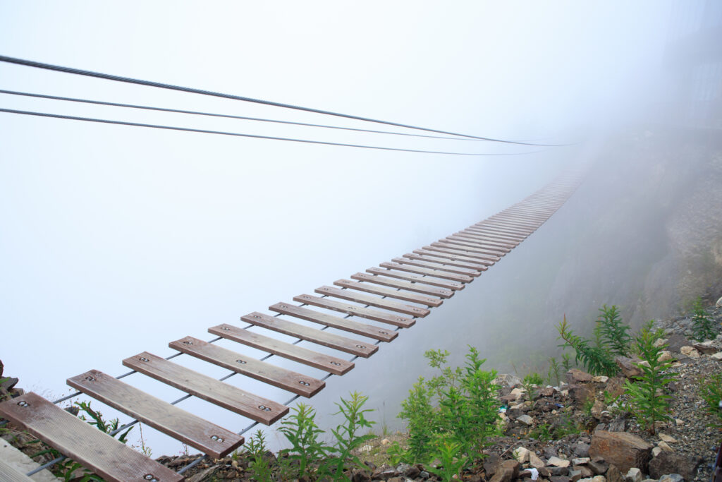 Suspension Bridge Vanishes into Fog - photo credit iStock