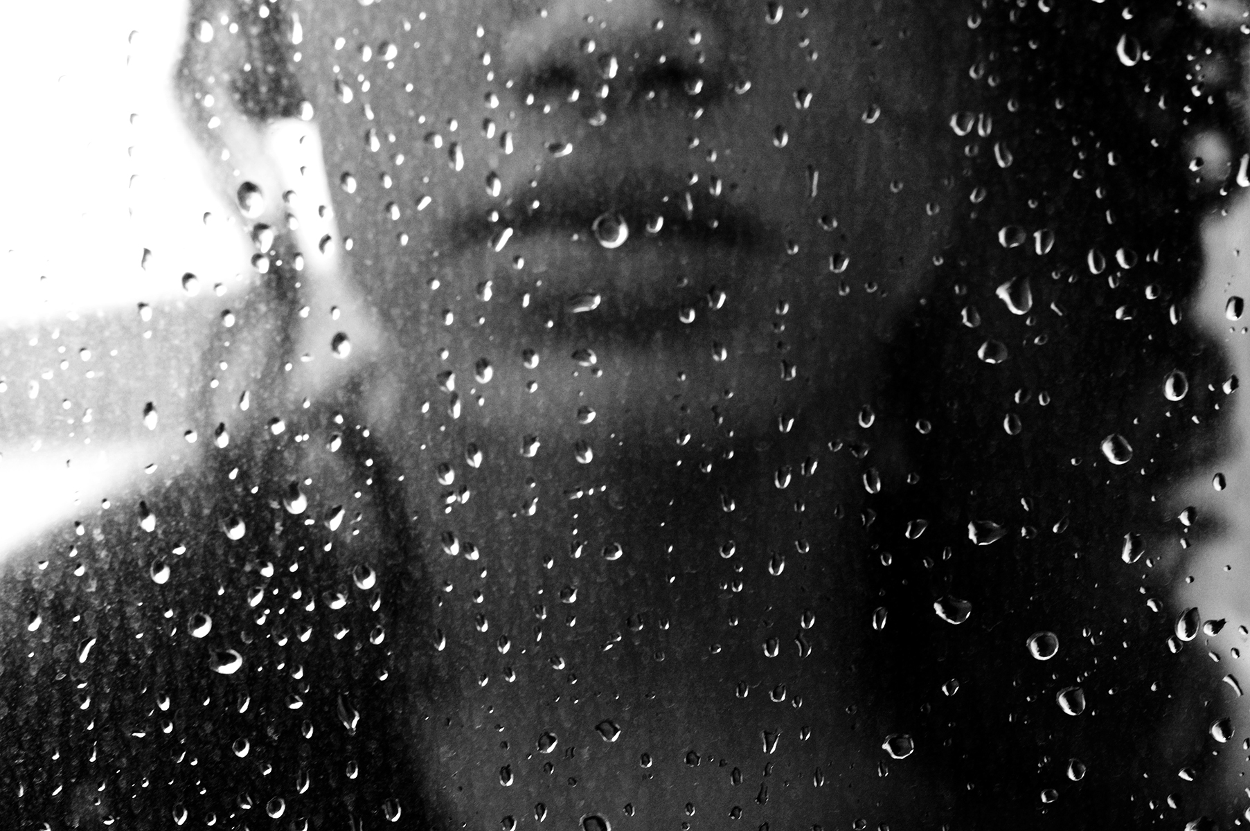 January in the PNW - Sad Woman Gazing Through Rainy Window - iStock 140477948